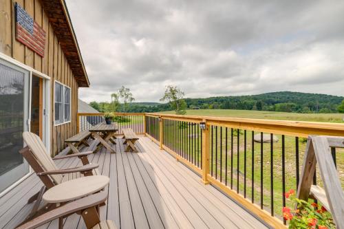 a deck with chairs and tables on a house at Lakeside Gem Hot Tub and Game Room in Hancock in Deposit