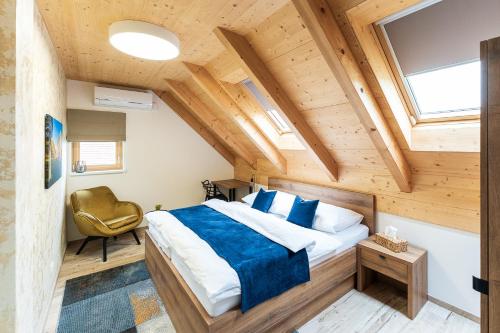 Un dormitorio con una cama grande en una habitación con techos de madera. en Penzion Nad Pavlovem, en Pavlov