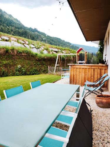 a table and chairs on a patio with a view at Appartements Amber in Kleinarl