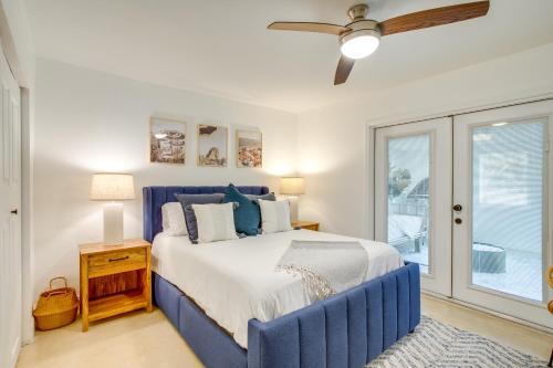 a bedroom with a blue bed and a window at Redington Beach Home Patio, Grill, Walk to Beach in St. Pete Beach