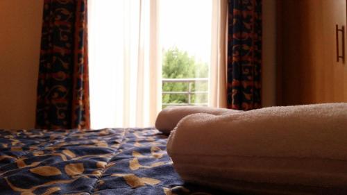 a bedroom with a bed and a window with a view at Palace Hotel Due Ponti in Siena