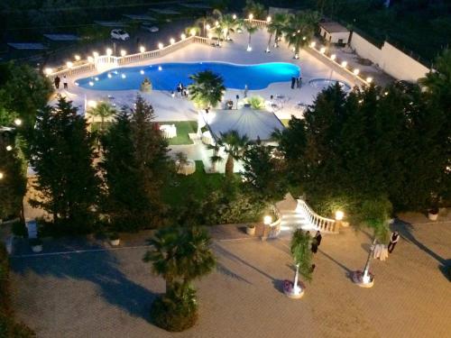 an overhead view of a swimming pool at night at Grand Hotel Stella Maris Italia in Palmi