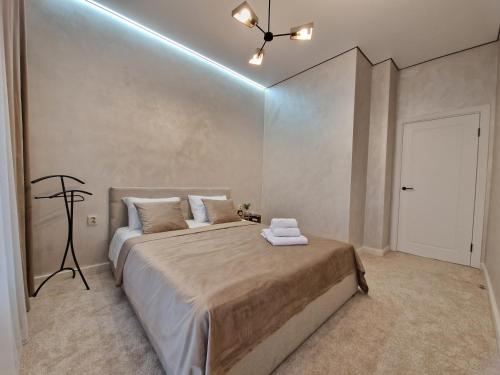 a bedroom with a large bed and a ceiling fan at Expo Residence Astana in Astana