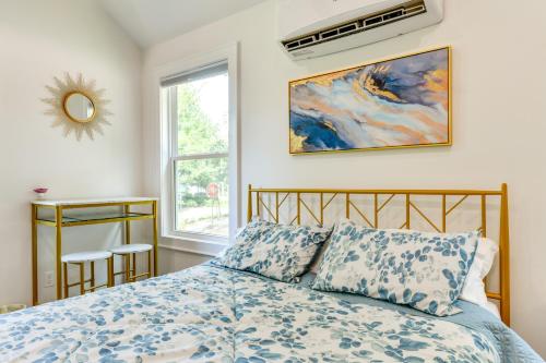 a bedroom with a bed with a blue comforter and a window at Charming Winston-Salem Studio on Miller Park! in Winston-Salem