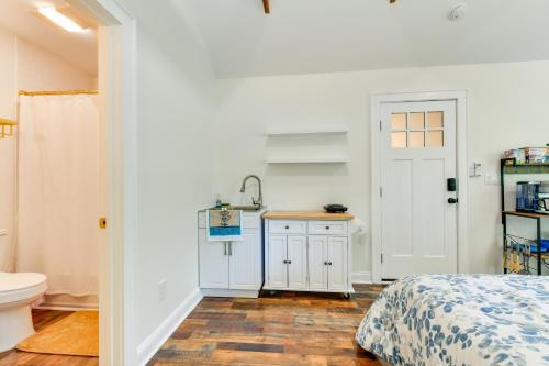 a bathroom with a bed and a sink and a toilet at Charming Winston-Salem Studio on Miller Park! in Winston-Salem