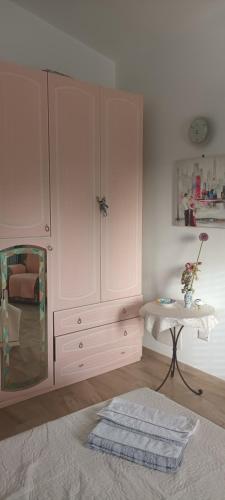 a room with a large white cabinet and a table at Insula -- Telti in Telti