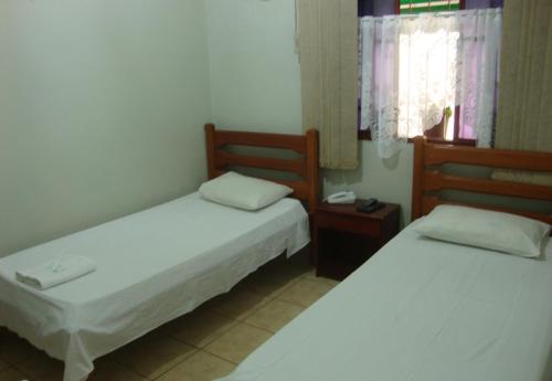 מיטה או מיטות בחדר ב-Pousada Dom Aquino