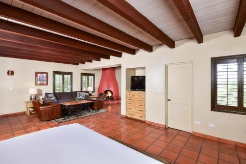 a bedroom with a bed and a living room at Lodge On The Desert in Tucson