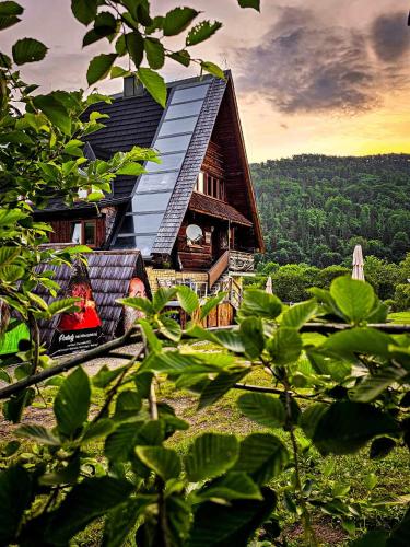 a house with a roof on top of a hill at Bacówka PTTK Jaworzec in Wetlina