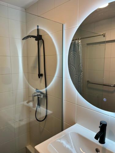a bathroom with a shower and a sink and a mirror at Vilvoorde city center in Vilvoorde