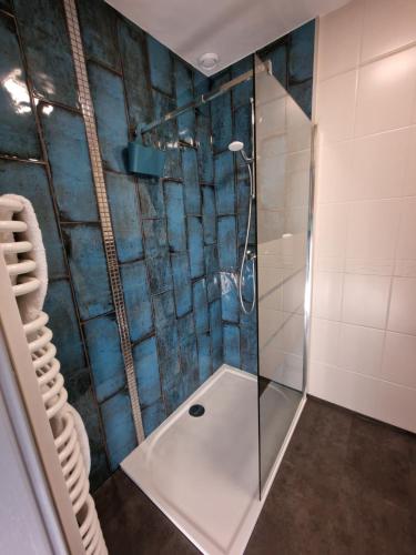 a bathroom with a shower with a glass door at Hotel Podróżnik in Koszuty