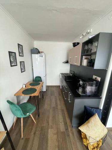 a small kitchen with a table and a refrigerator at 1-izbový byt in Košice