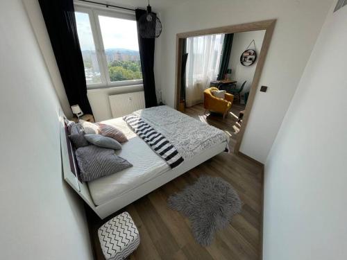 a view of a bedroom with a bed and a mirror at 1-izbový byt in Košice