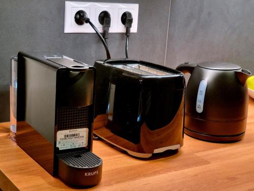 a coffee maker and a toaster on a table at B40 Green ApartRooms in Budapest