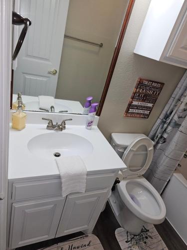 a bathroom with a white sink and a toilet at KING BED! Walk To AT&T Stadium, Globe Life in Arlington