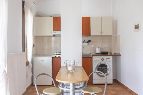a kitchen with a table and chairs in a room at The Olympus Garden Beach House in Litochoro