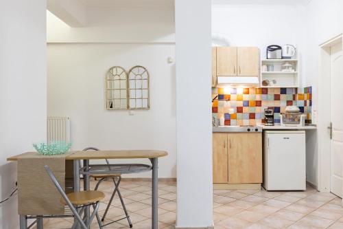 a kitchen with a table and chairs in a room at The Olympus Garden Beach House in Litochoro