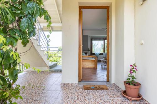 a hallway with a door leading into a room at The Olympus Garden Beach House in Litochoro