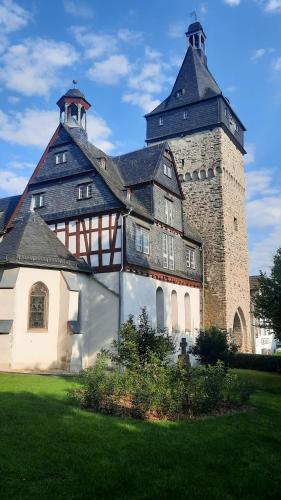a large building with a tower on top of it at Ferienwohnung Am Kurpark in Bad Camberg