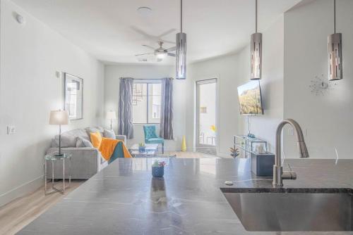 a kitchen with a sink and a living room at Private Rooftop Terrance-Walk Score 81-Shopping District-King Bed-Parking 4021 in Scottsdale