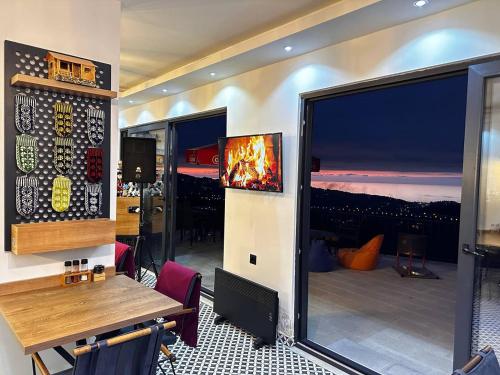 a dining room with a table and a large window at Moon House Bungalow in Rize