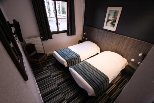 Postel nebo postele na pokoji v ubytování Hotel Bollaert