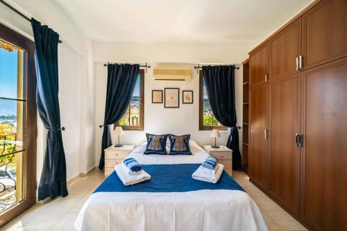 a bedroom with a large bed with blue sheets at Azure Apartment with Sea view in Kalkan in Kalkan