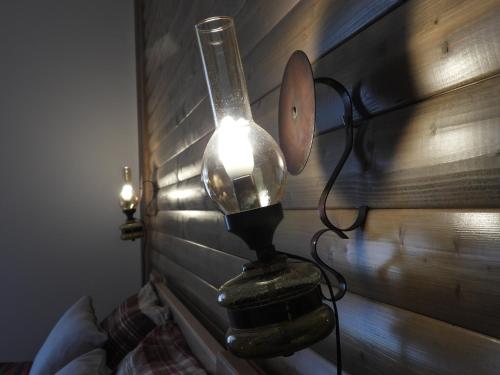 a lamp hanging on the wall of a bedroom at Zimski san in Ravna Gora