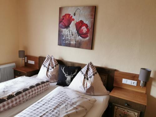 a bedroom with two beds and a painting on the wall at Alpengasthof Fernblick in Mönichkirchen