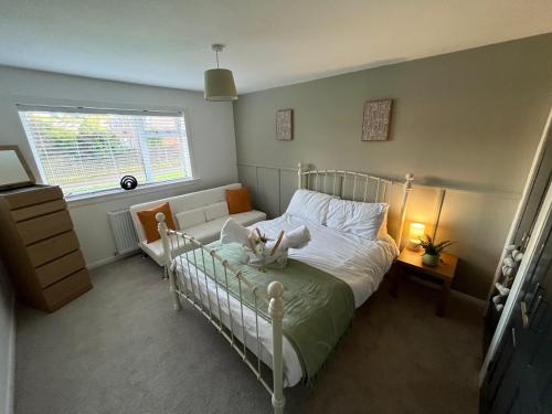 a bedroom with a bed with a cat on it at Erskine Apartment in Erskine