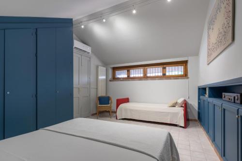 a bedroom with two beds with blue cabinets at Villa Rose Acireale Santa Tecla in Santa Tecla