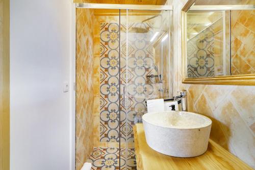 a bathroom with a sink and a mirror at Charming Amieira's Alqueva in Amieira