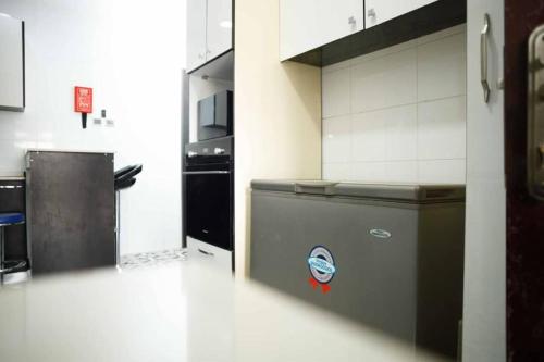 a kitchen with a counter and a refrigerator at DMK Shared Apartments in Abuja