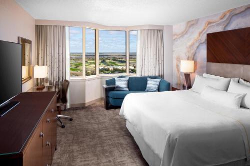 a hotel room with a bed and a couch at The Westin Savannah Harbor Golf Resort & Spa in Savannah