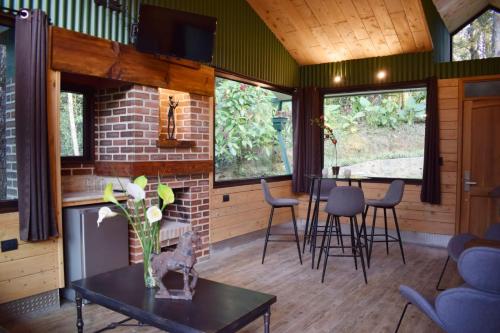 a living room with a table and chairs at Park Hotel in Santa Cruz Verapaz