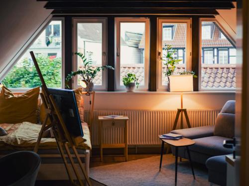 a living room with windows and a couch at Gemütliche Oase in Detmolder City in Detmold