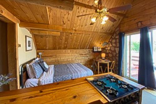 a bedroom with a bed and a stove in it at Sunny Acres Cabin in Moab
