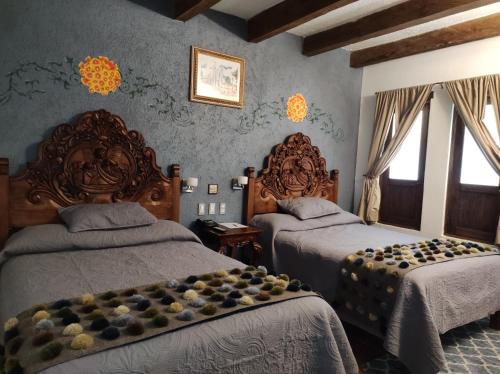 En eller flere senge i et værelse på Hotel Grand Maria
