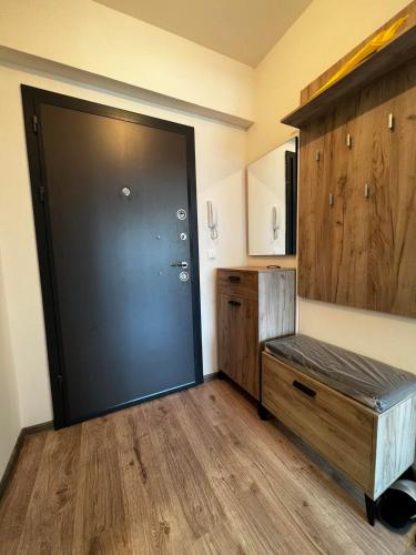 a room with a black door and a wooden floor at Apartman Paradise Fojnica in Fojnica