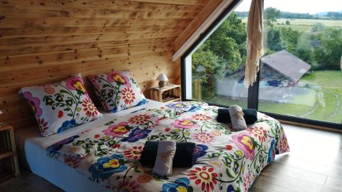 a bedroom with a bed with a large window at Pod Aniołem in Świerzawa