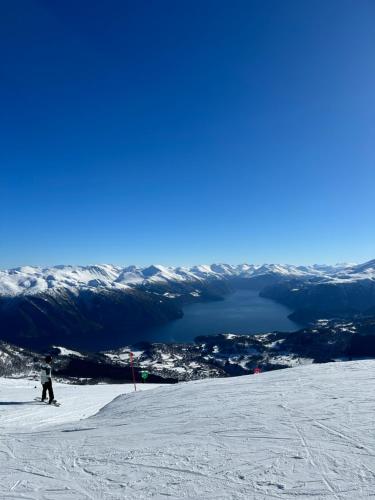 a person is skiing down a snow covered slope at Roalden Mountain Lodge in Stranda