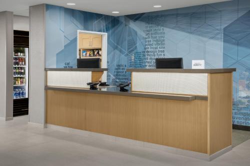a reception counter in a store with a blue wall at SpringHill Suites by Marriott Portland Vancouver in Vancouver