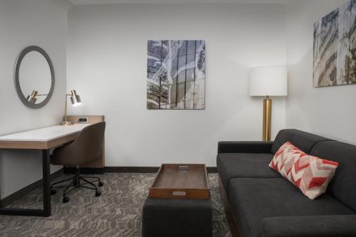 a living room with a couch and a desk at SpringHill Suites by Marriott Portland Vancouver in Vancouver