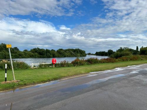 a road with a red stop sign next to a river at Ralph’s Retreat in Cottam