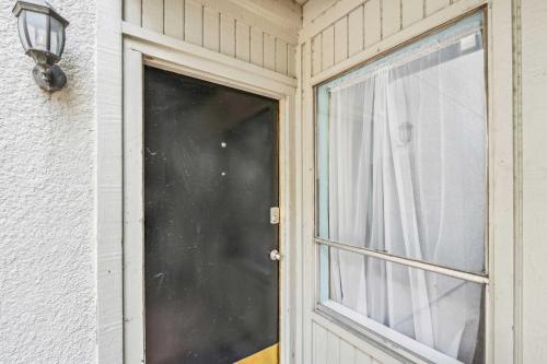a door with a window next to a building at Dallas Condo with Pool Access about 4 Mi to Downtown! in Dallas
