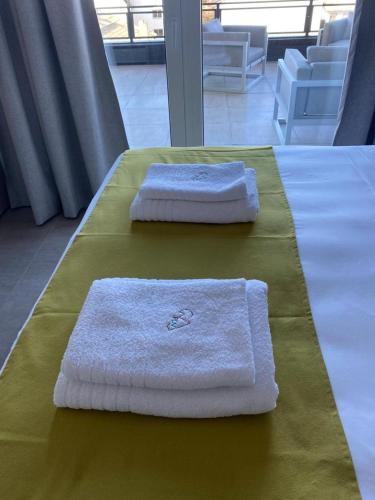 two towels sitting on a table in a room at Patagonia Deluxe View in San Carlos de Bariloche