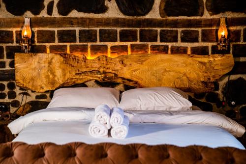 a bed with two pairs of slippers on it at Kervan Konaklama in Ardeşen