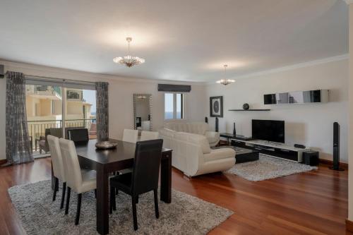 a living room with a table and a dining room at Vila Formosa II by An Island Apart in Funchal