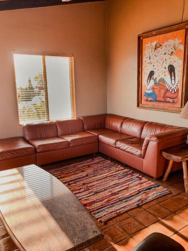 a living room with a brown leather couch at Su Casa in Ensenada