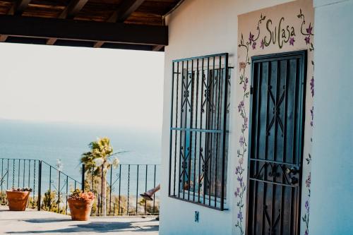 a building with a door with a view of the ocean at Su Casa in Ensenada